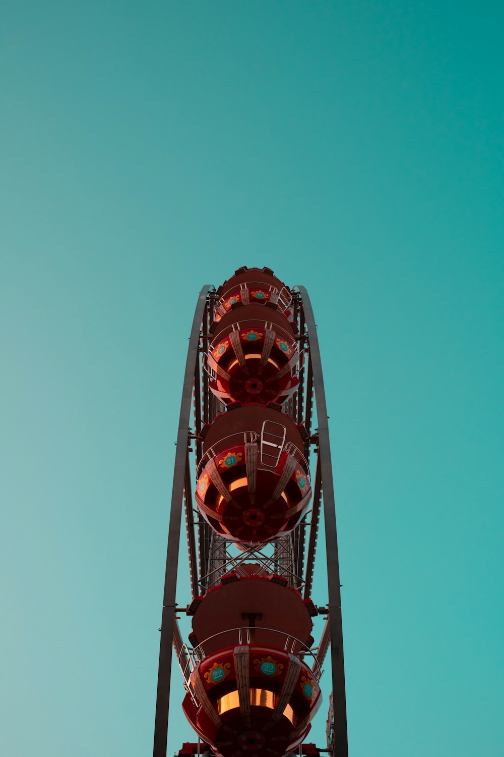 a red ferris wheel against a blue sky