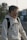 a young man wearing a white sweatshirt and black backpack