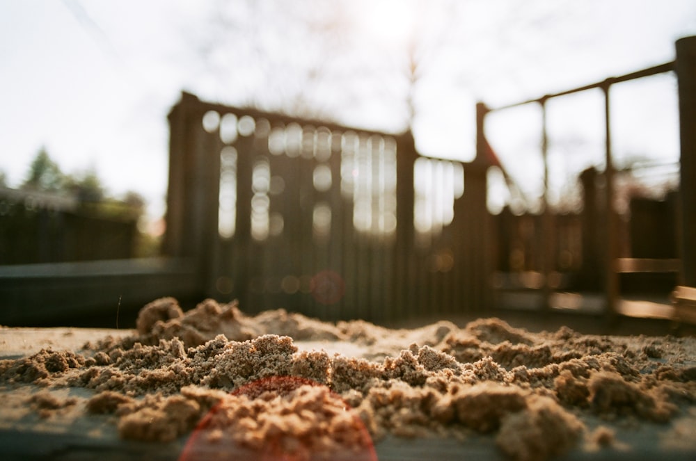 a pile of sand sitting on top of a sidewalk