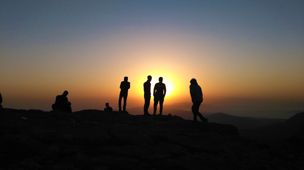 a group of people standing on top of a mountain