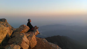 Peaceful moment of meditation on a cliff with panoramic views of Taghazout bay