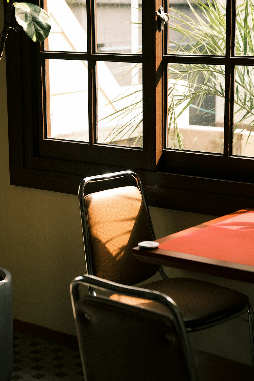 a chair and a table in front of a window