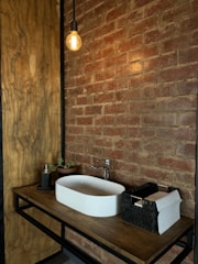Cozy bathroom featuring warm wood accents and updated vanity lighting