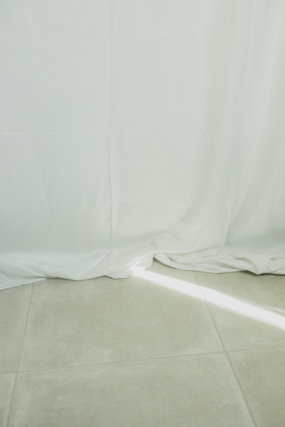 a white wall with a white sheet covering it