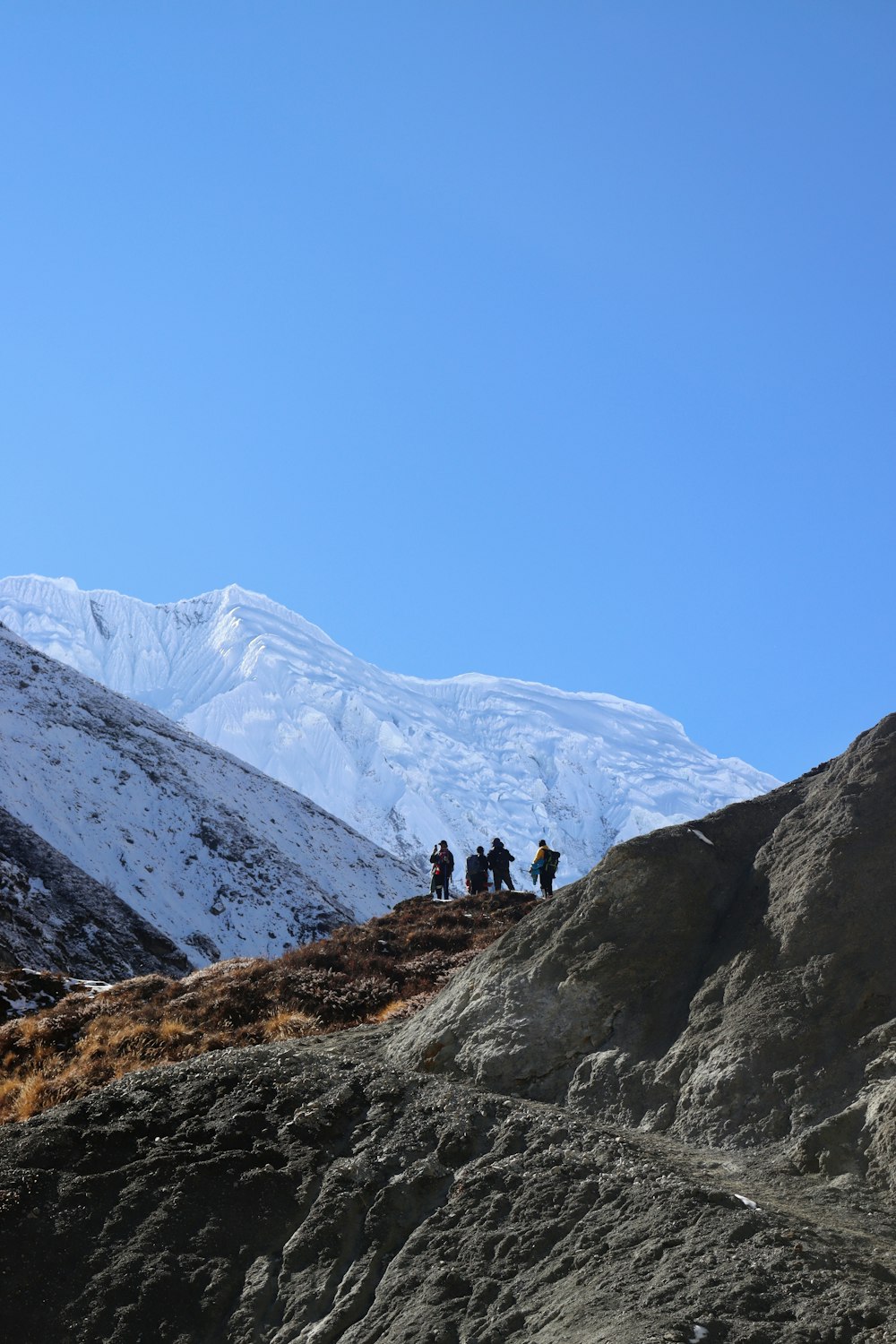 a group of people walking up a mountain side