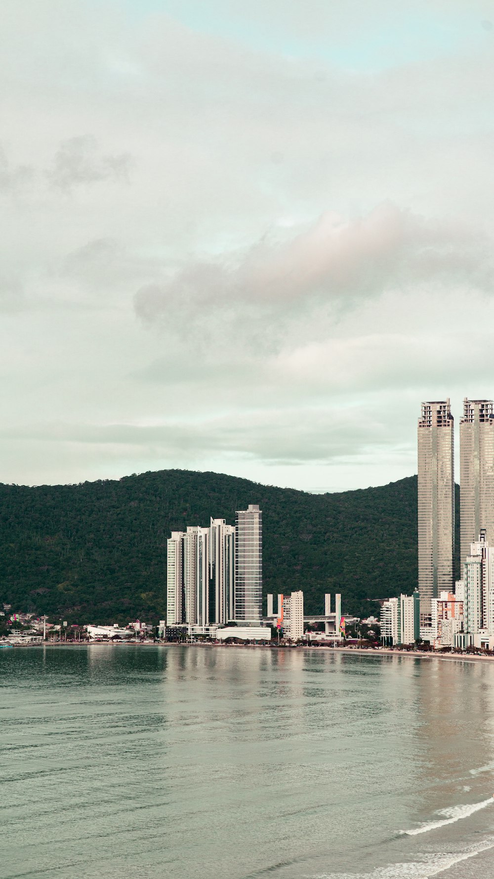 a large body of water with a city in the background