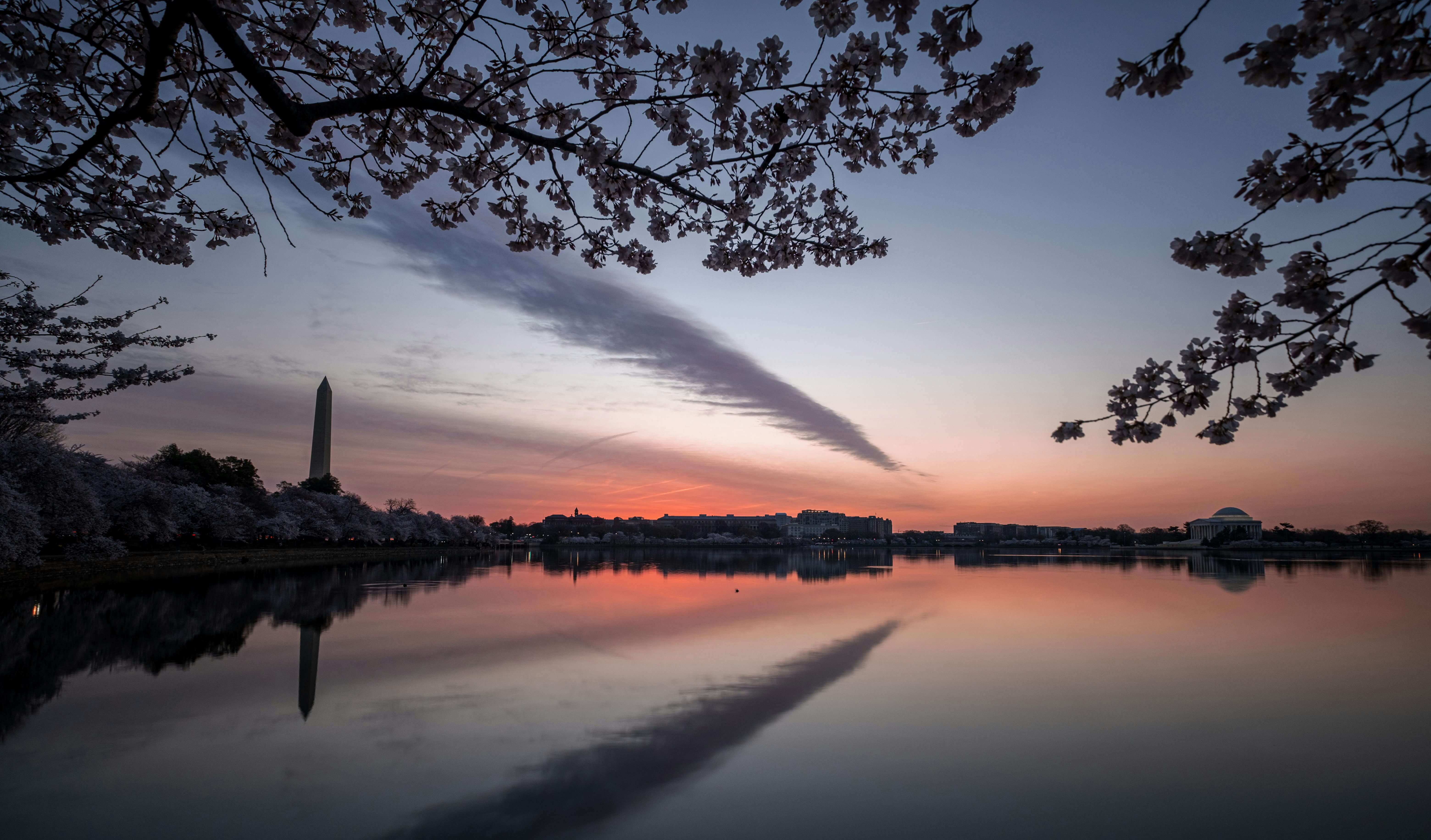the washington monument is reflected in the water, 