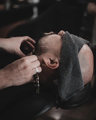a man getting his hair cut by a barber
