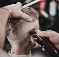 a man getting his hair cut by a barber