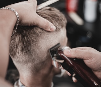 a man getting his hair cut by a barber