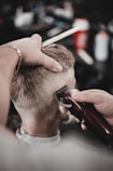 a man getting his hair cut by a barber