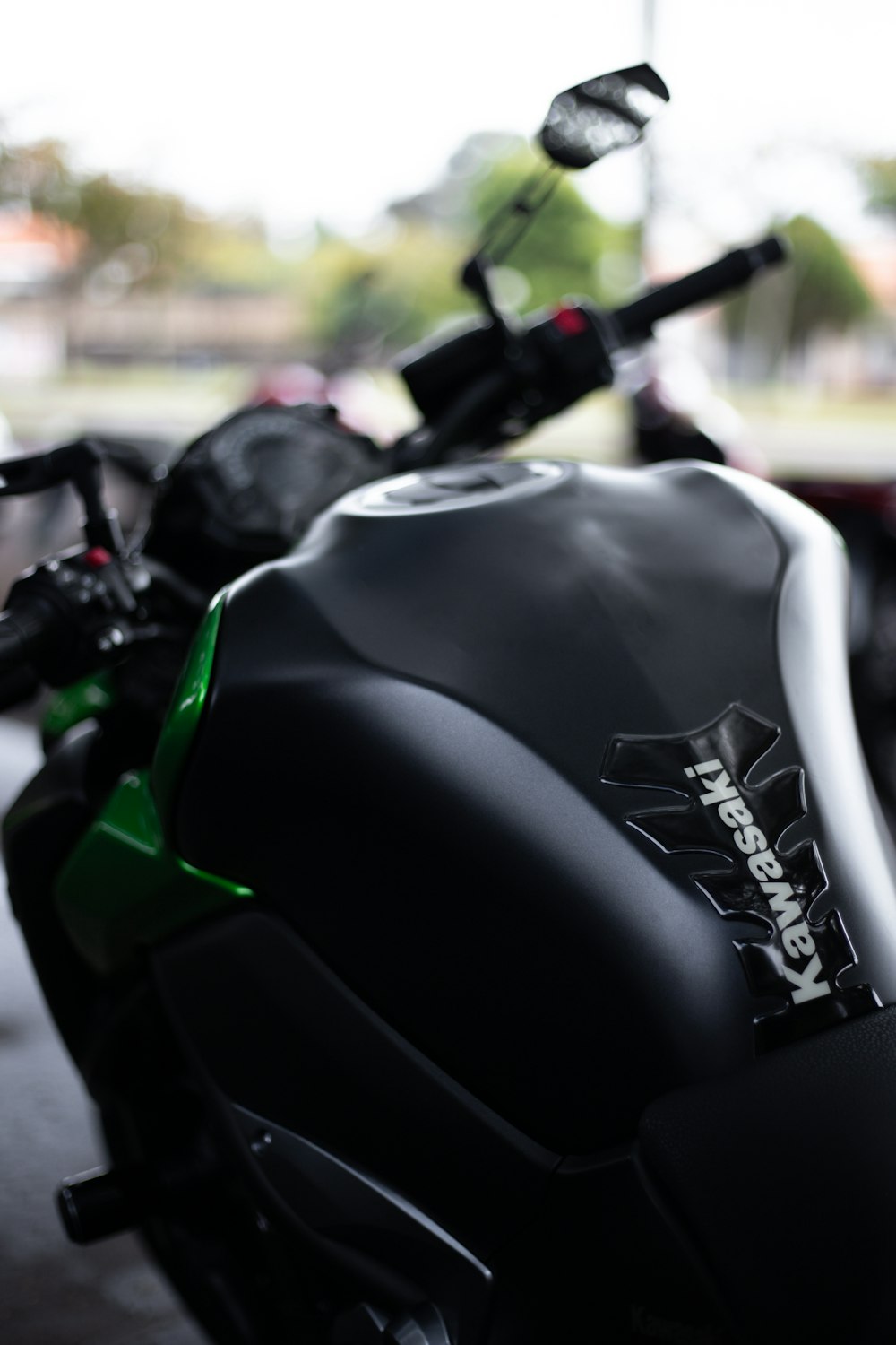 a close up of a motorcycle parked in a parking lot