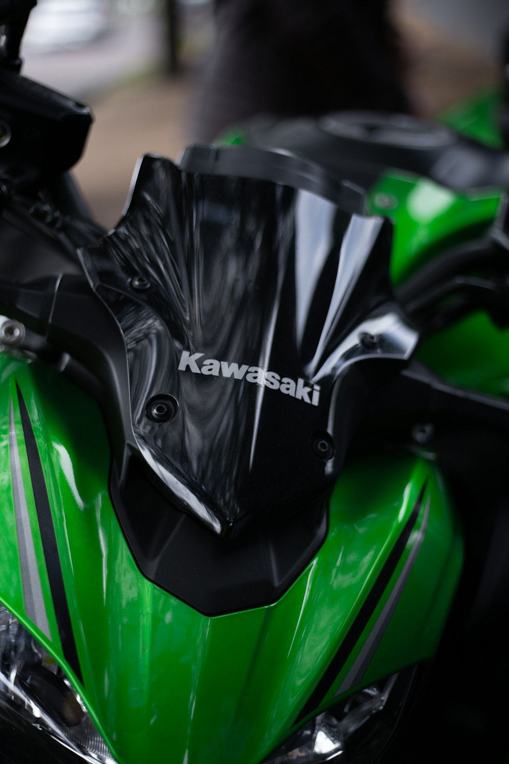 a close up of a green and black motorcycle