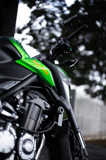 Close-up of a sleek black motorcycle jacket with neon green accents under soft lighting