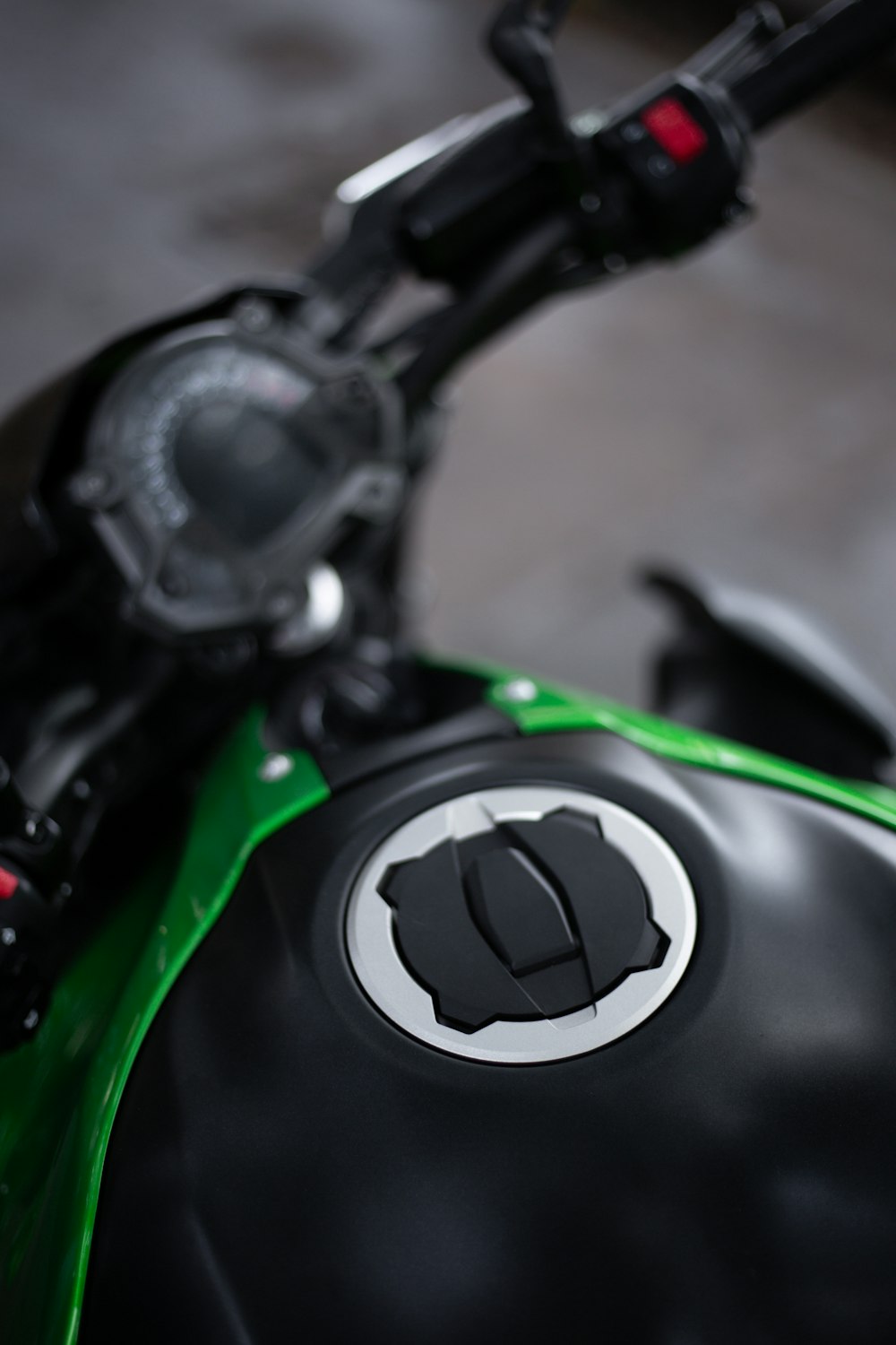 a close up of a green and black motorcycle