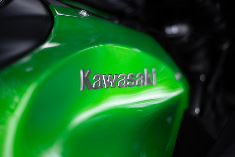 a close up of a green motorcycle with the words kawasaki on it
