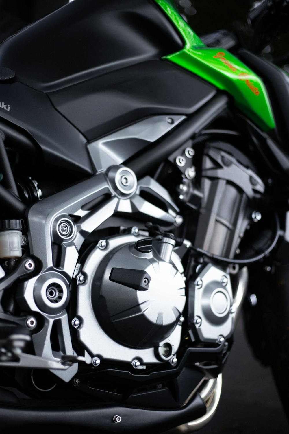 a close up of a green and black motorcycle