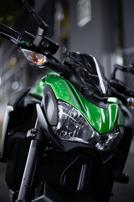 Close-up of a sleek black motorcycle jacket with neon green accents under dynamic lighting.