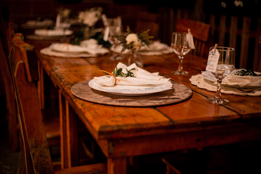 a wooden table topped with a white plate covered in flowers