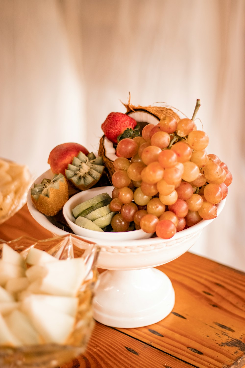 a bowl of fruit is on a table