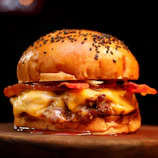 A sizzling beef burger topped with melted cheese and crispy lettuce in a toasted bun.