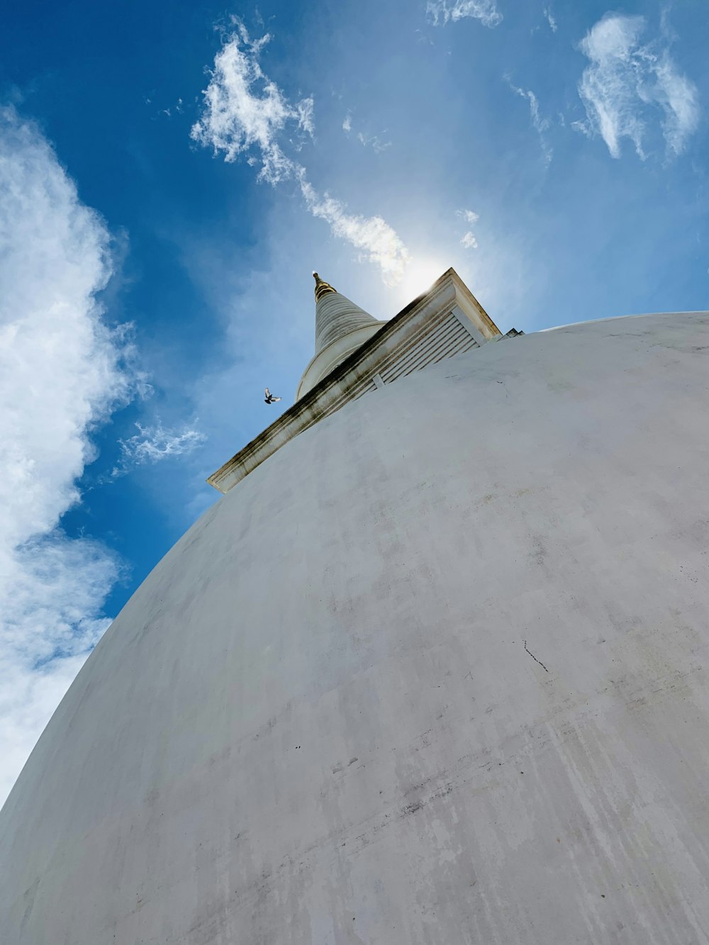 the top of a building with a blue sky in the background