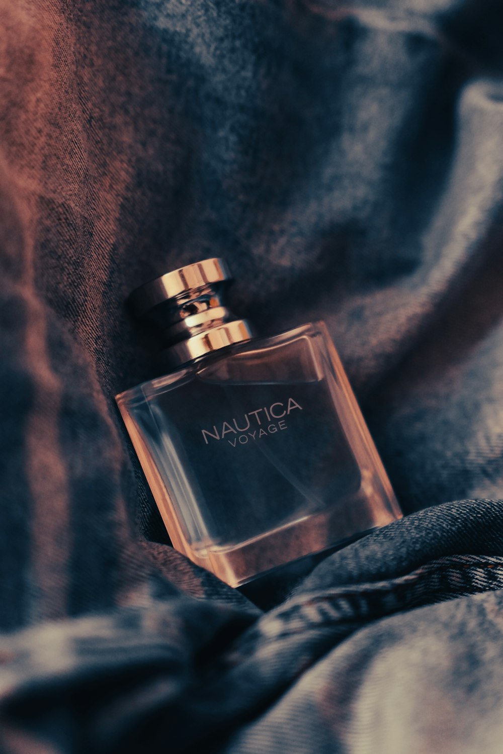 a bottle of nautica on a blanket