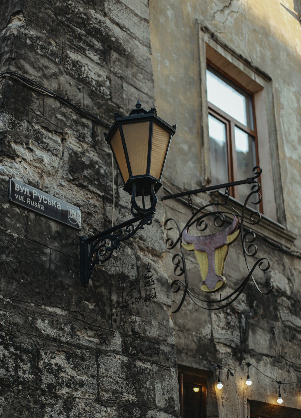 a street light hanging from the side of a building