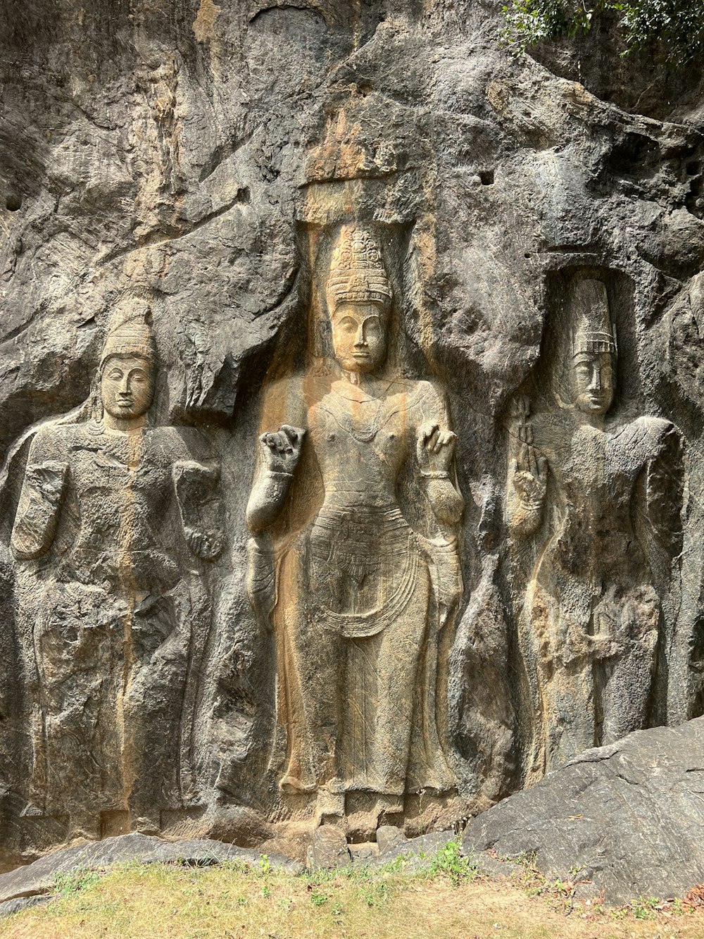 a group of statues on the side of a mountain