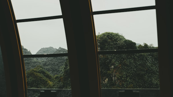 Serene mountain view framed by large panoramic windows.