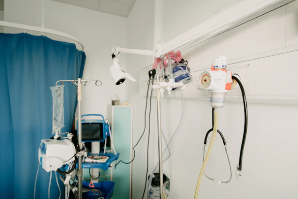 A dedicated critical care nurse monitoring ICU equipment in a hospital setting.