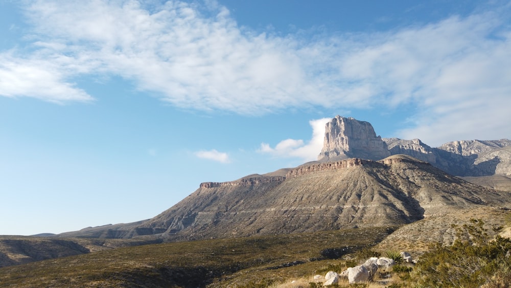 a view of a mountain with a cloud in the sky