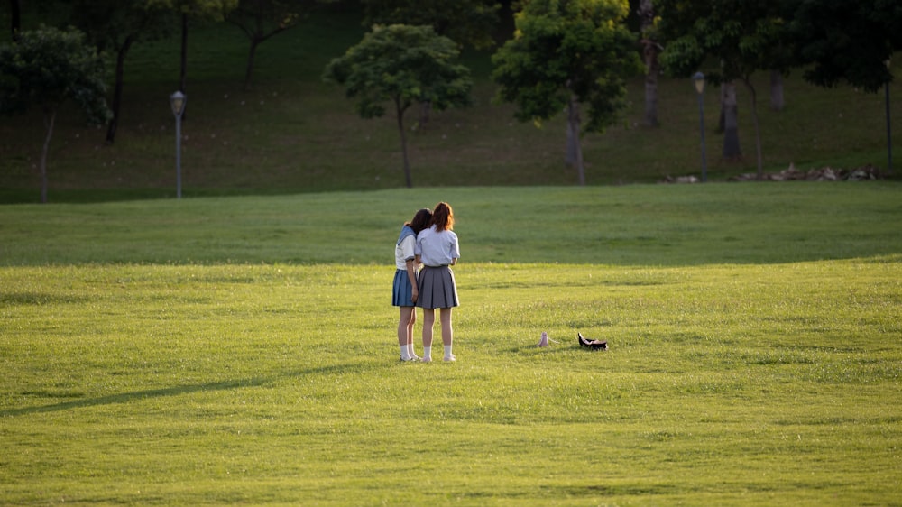 a woman standing in a field with her back to the camera