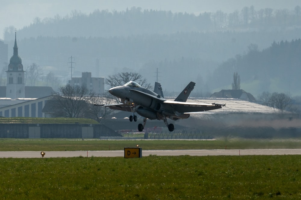 a fighter jet taking off from an airport runway