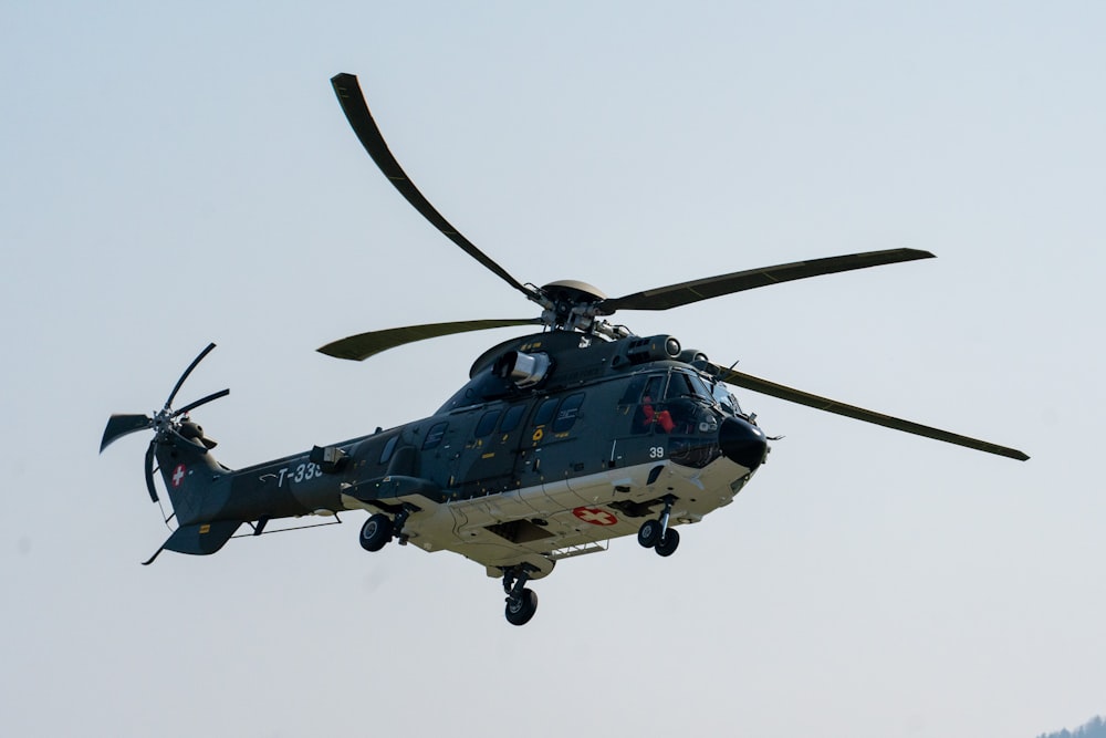 a helicopter flying in the air with a sky background