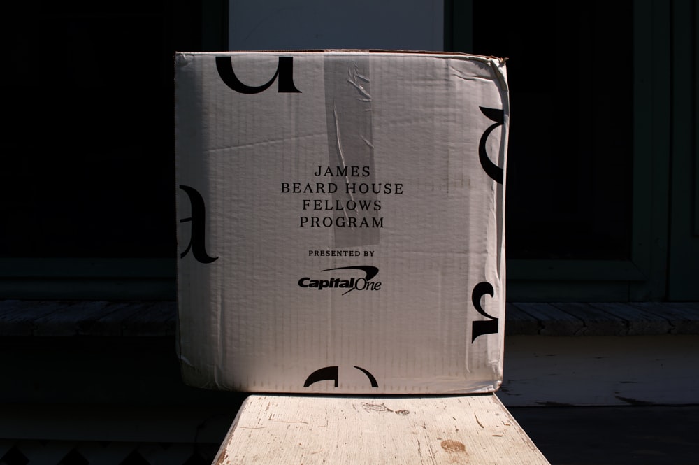 a cardboard box sitting on top of a wooden bench