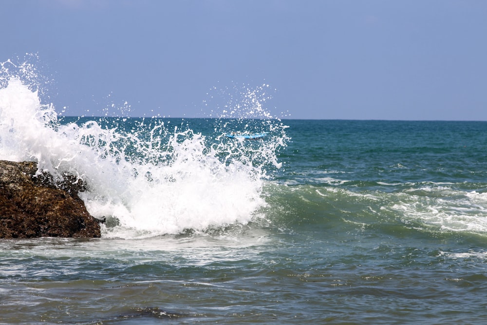 a person riding a surfboard on top of a wave