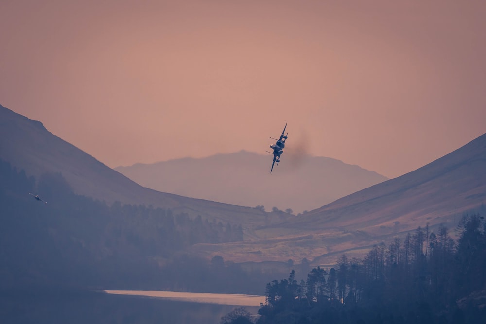 a plane is flying over a mountain range