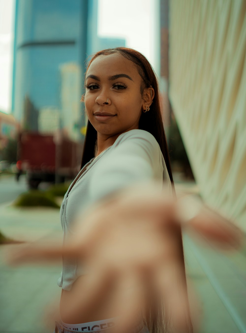 a woman standing in front of a tall building