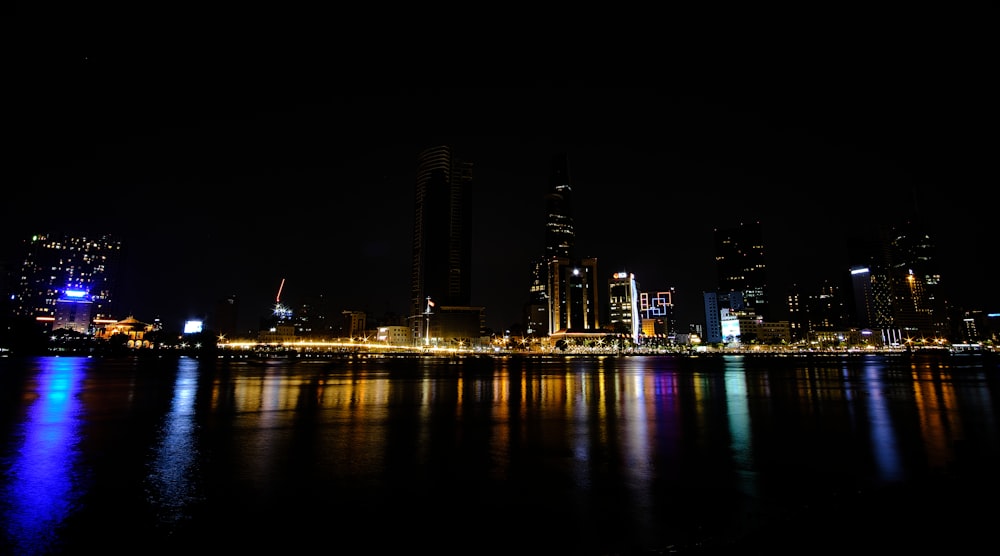 a city skyline is lit up at night