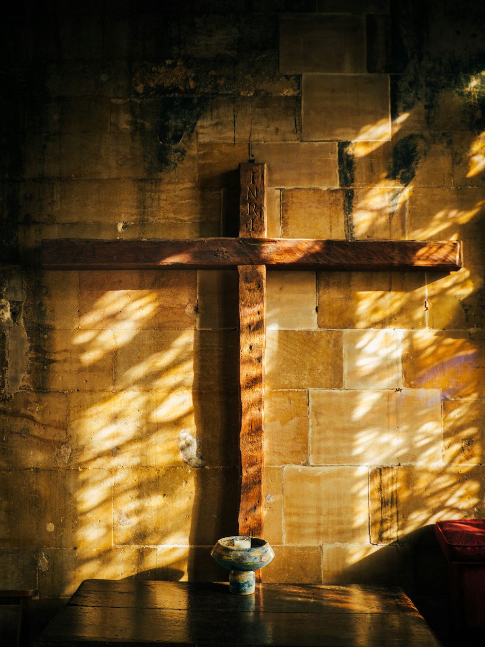 a cross on a wall in a church