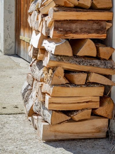 a pile of wood sitting on the side of a building