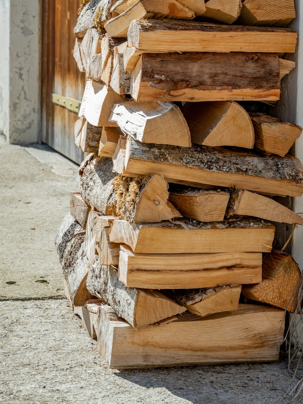 a pile of wood sitting on the side of a building