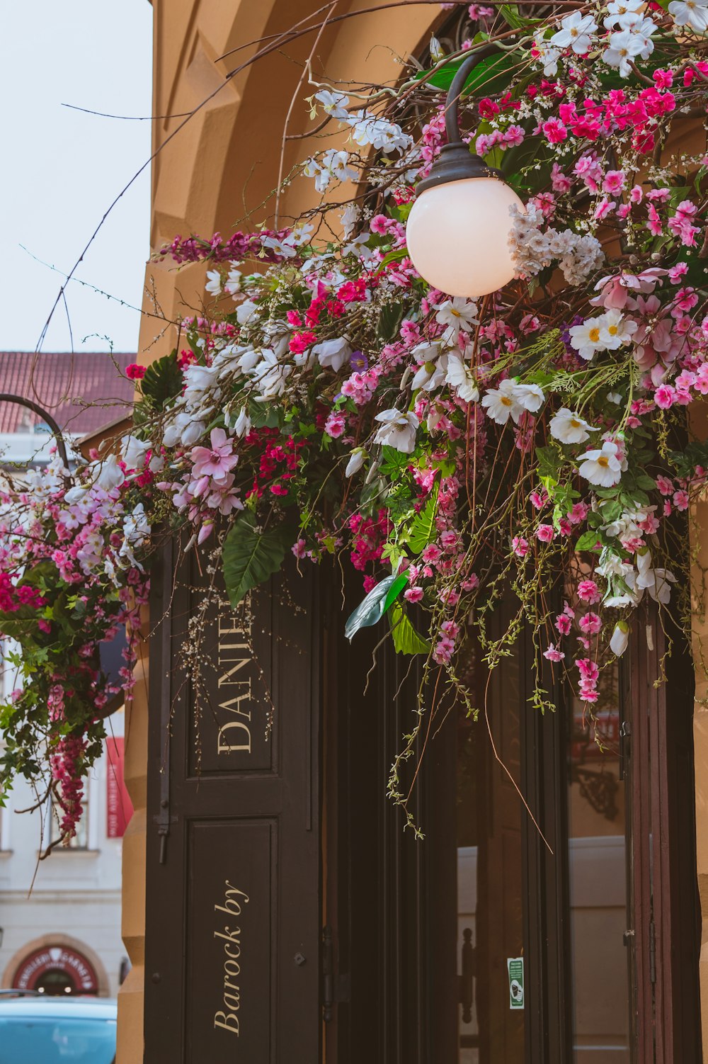 a building with a bunch of flowers hanging from it's side