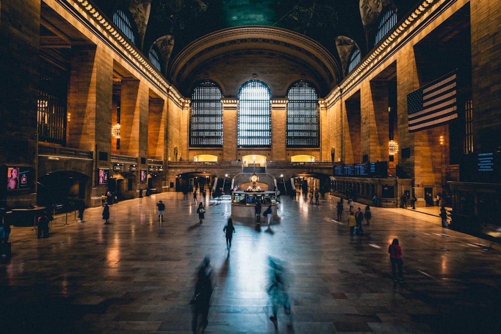 a group of people walking through a train station