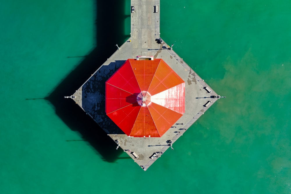 an overhead view of a red and orange umbrella