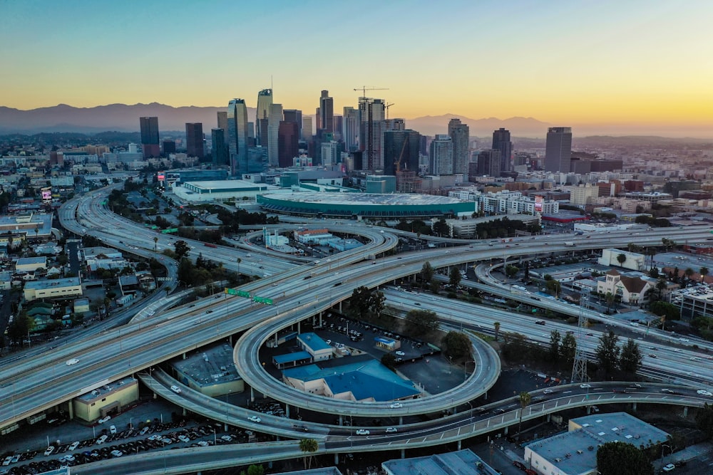 an aerial view of a highway intersection with a city in the background