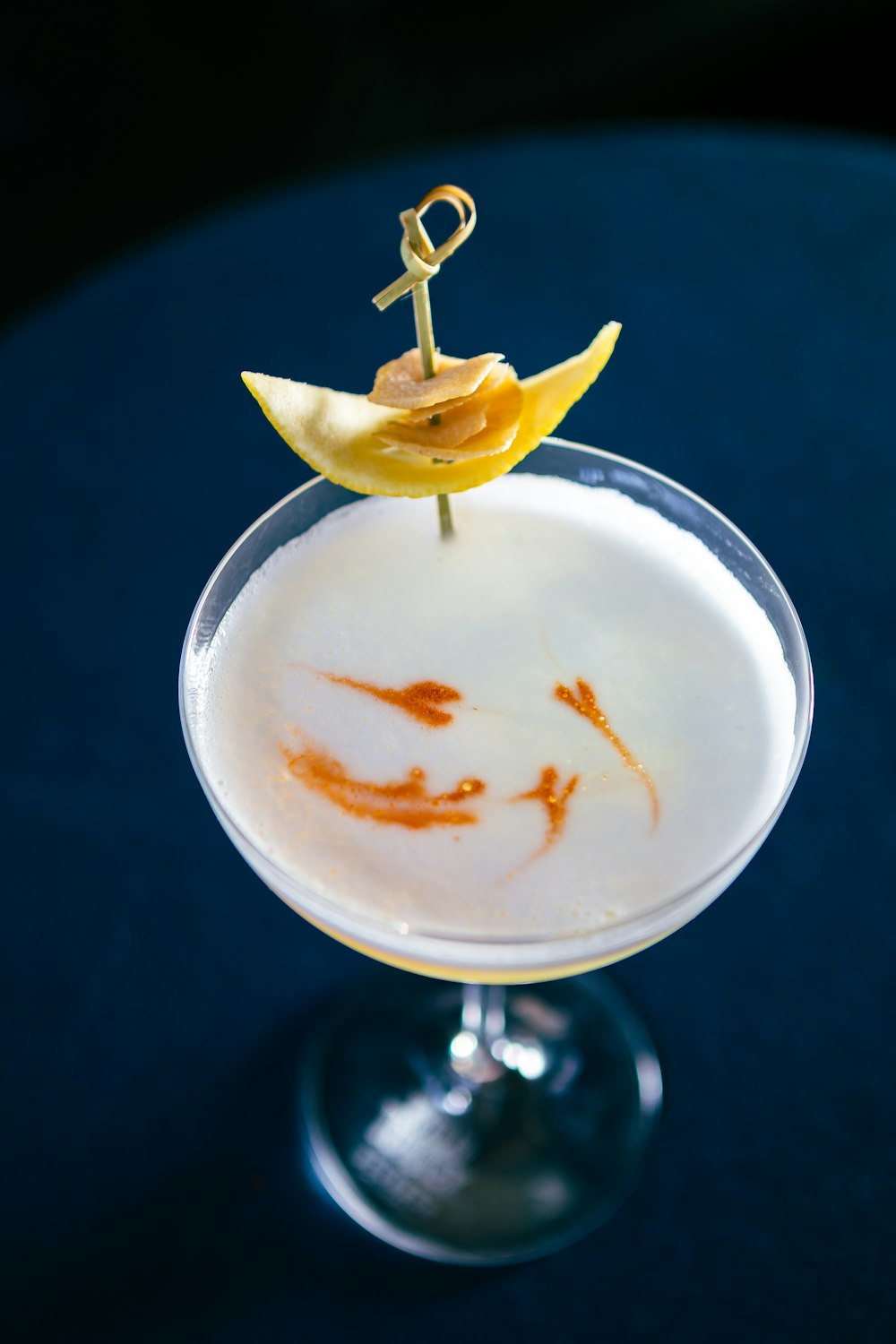 a glass with a drink on a table