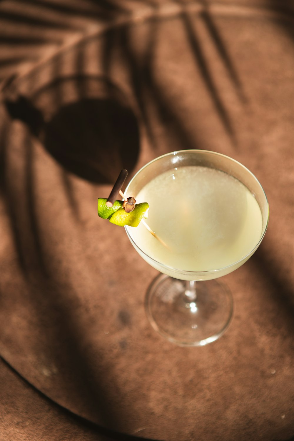 a glass filled with a drink sitting on top of a table