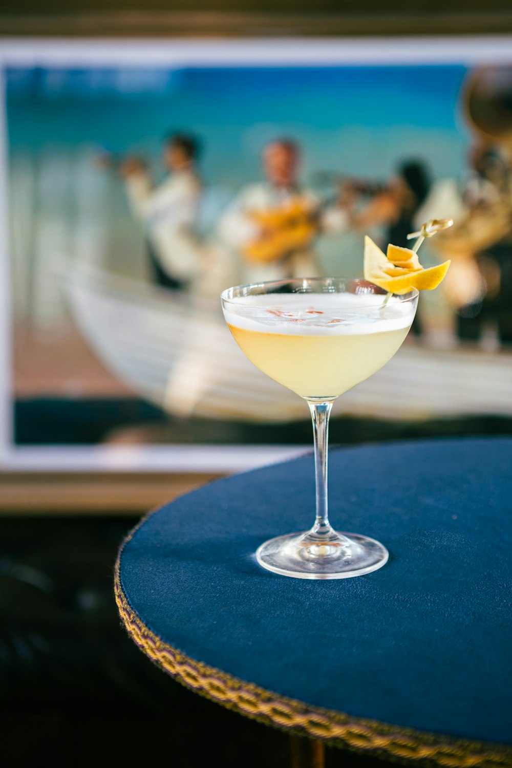 a martini sitting on top of a table next to a tv